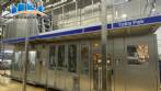 Tetra Pak aseptic filling line featuring the A3 Flex filling machine, Cardboard Packer 70, and Tray Shrink 51 shrink-wrapping machine.